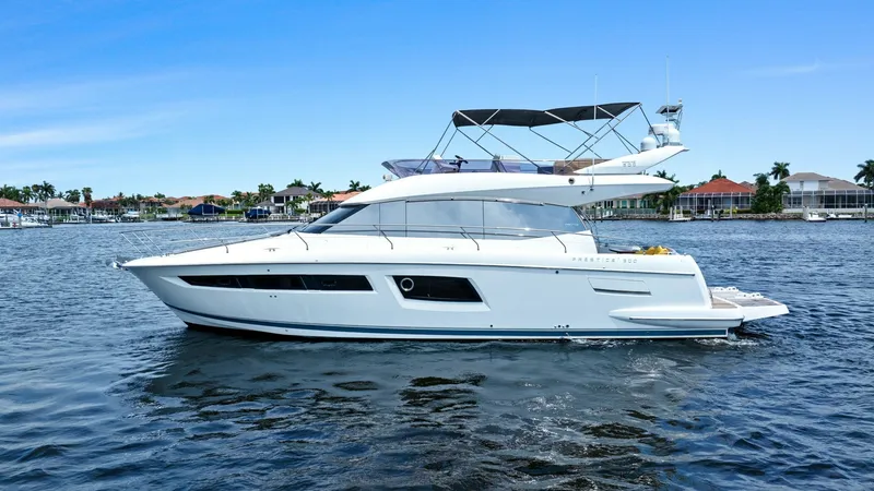 Slide: The Image of Side Profile of Prestige 500 Fly This image showcases the sleek side profile of the 2015 Prestige 500 Fly, highlighting its elegant lines and modern design. The yacht's flybridge is prominently visible, offering an expansive area for relaxation with panoramic views. The vessel's streamli - 7603833