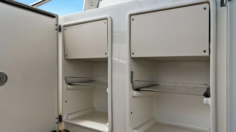 Slide: The Image of Aft Deck Storage Compartments The Prestige 500 Fly features practical aft deck storage compartments, perfect for organizing essential gear. These compartments are neatly integrated, with easy-access doors and durable shelving to maximize space. The clean, white finish complements the - 7603768
