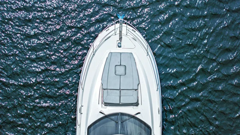 Slide: The Image of Aerial View of Bow Sunpad This image captures the sleek bow of the 2015 Prestige 500 Fly, showcasing a spacious sunpad perfect for relaxation. The cushioned area offers ample room for sunbathing and enjoying panoramic views of the water. The high-quality finishes and elegant desig - 7603831