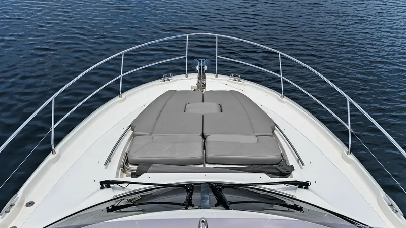Slide: The Image of Spacious Forward Sunbathing Area The forward deck of the 2015 Prestige 500 Fly features a luxurious sunbathing area with plush, cushioned loungers. Designed for ultimate relaxation, this space allows for unobstructed views and a serene experience while cruising. The sleek, stainless stee - 7603764