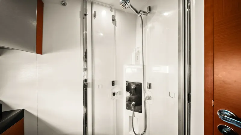 Slide: The Image of Luxury Ensuite Shower This elegant ensuite shower aboard the 2015 Prestige 500 Fly offers a sleek, modern design with high-quality fixtures. The spacious glass enclosure and polished chrome accents create a luxurious bathing experience. Rich wood finishes add a touch of sophis - 7603812