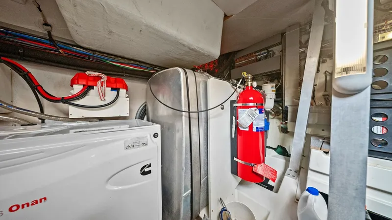 Slide: The Image of Engine Room with Generator The engine room of the 2015 Prestige 500 Fly showcases a well-organized layout featuring a Cummins Onan generator. Essential safety equipment, including a fire extinguisher, is conveniently accessible, ensuring peace of mind during voyages. The space is e - 7603822