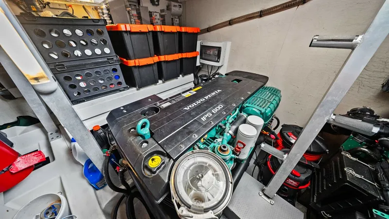 Slide: The Image of Engine Room with Volvo Penta IPS 600 This image showcases the engine room of the YachtWave, featuring a powerful Volvo Penta IPS 600 engine. The space is well-organized with easy access to controls and essential components, ensuring efficient maintenance and operation. The layout emphasizes - 7603820
