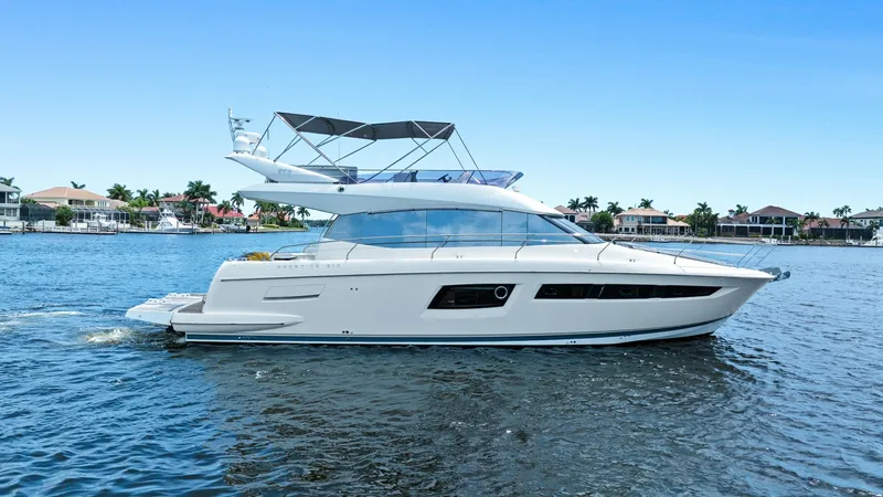 The Image of Starboard Profile of Prestige 500 Fly This image showcases the sleek starboard profile of the 2015 Prestige 500 Fly. The yacht's elegant lines are complemented by large panoramic windows, allowing for abundant natural light and breathtaking views. The flybridge is equipped with a stylish bimi - 7603746