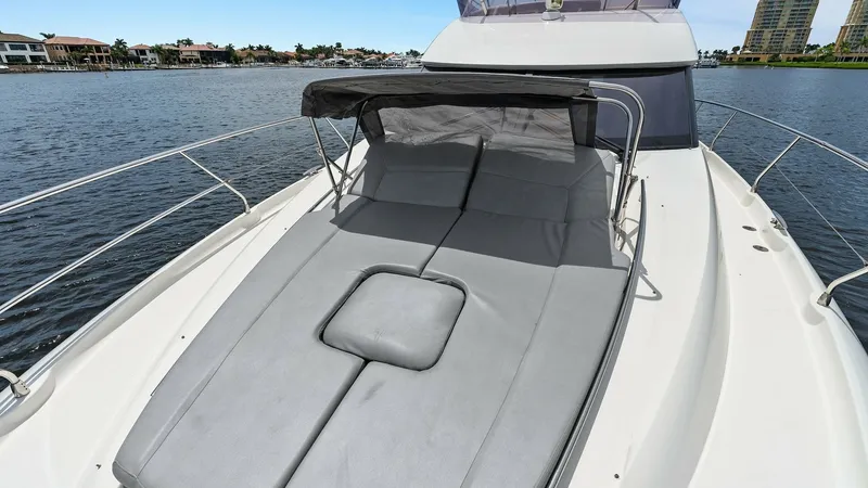 Slide: The Image of Spacious Foredeck Sunpad Area The Prestige 500 Fly features a luxurious foredeck sunpad with adjustable backrests, perfect for soaking up the sun. The area is equipped with a sleek, retractable bimini for added shade and comfort. Its expansive layout offers a relaxing vantage point to - 7603775