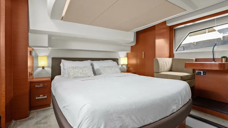Slide: The Image of Master Stateroom with Double Bed The master stateroom offers a luxurious retreat featuring a spacious double bed with plush bedding. Warm wood finishes complement the soft, ambient lighting, creating a serene atmosphere. A large window provides natural light and a beautiful view, enhanci - 7603797