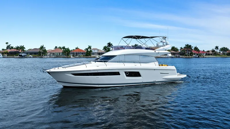 Slide: The Image of Port Side View of YachtWave This striking image showcases the sleek profile of the 2015 Prestige 500 Fly, highlighting its elegant lines and modern design. The spacious flybridge is visible, offering ample space for relaxation and panoramic views. The clean, contemporary exterior re - 7603832