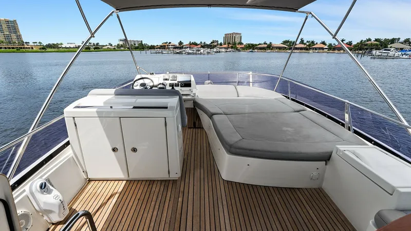 Slide: The Image of Flybridge with Sunpad and Helm The flybridge of the 2015 Prestige 500 Fly offers a spacious sunpad area for relaxation and panoramic views. The helm is strategically positioned, providing excellent visibility and easy access to controls. Teak decking adds a touch of elegance, while the - 7603770