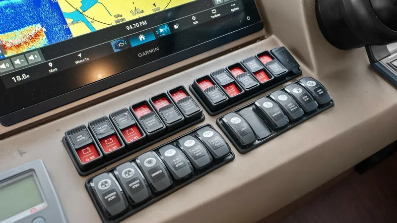 Slide: The Image of Helm Control Panel with Electronics The helm of the 2015 Prestige 500 Fly features a sophisticated control panel with an integrated Garmin navigation system. Sleek and modern, the array of switches and controls provides easy access to essential functions, ensuring smooth and efficient opera - 7603794