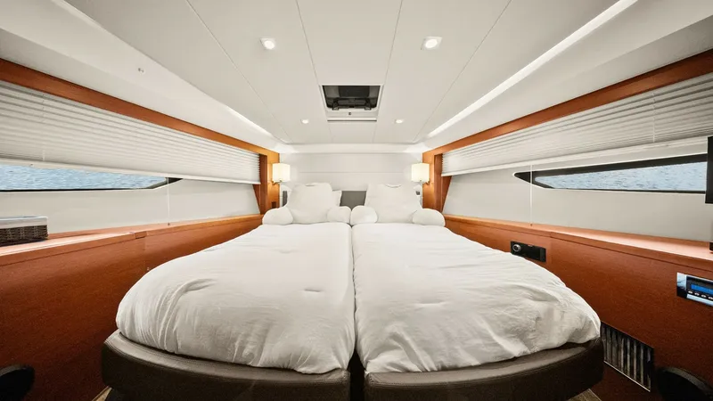 Slide: The Image of Luxurious Forward Stateroom The forward stateroom of the 2015 Prestige 500 Fly offers a spacious and inviting retreat. The twin beds can be converted into a double, maximizing comfort and flexibility for guests. Natural light floods the room through sleek side windows, while elegant - 7603809