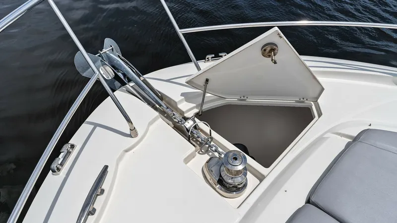 Slide: The Image of Bow Anchor System and Storage The Prestige 500 Fly's bow features a sleek anchor system with an integrated windlass, ensuring easy mooring. The deck's clean lines are complemented by a spacious storage compartment, perfect for securing essential gear. This area provides a practical an - 7603773