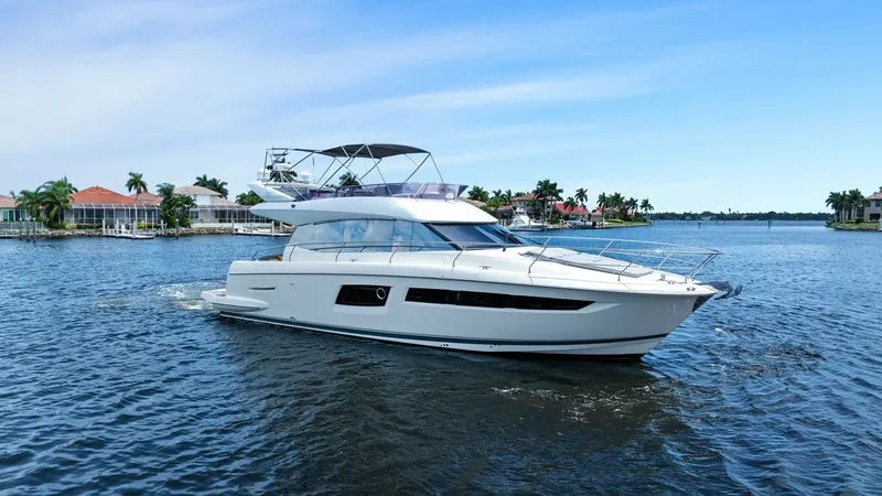Slide: The Image of Side View of Prestige 500 Fly This image showcases the sleek side profile of the 2015 Prestige 500 Fly, highlighting its elegant lines and modern design. The yacht's expansive flybridge is visible, offering ample outdoor space for relaxation and panoramic views. The large windows alon - 7603827