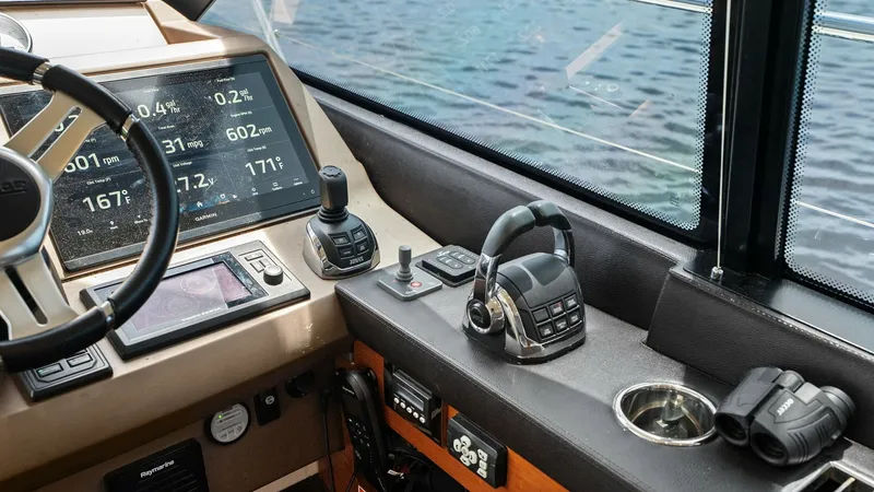 Slide: The Image of Helm Station with Navigation Controls The helm station of the Prestige 500 Fly showcases advanced navigation controls and instrumentation. A large, multifunction display offers clear readouts for speed and navigation data, while ergonomic throttle and joystick controls ensure precise maneuver - 7603791
