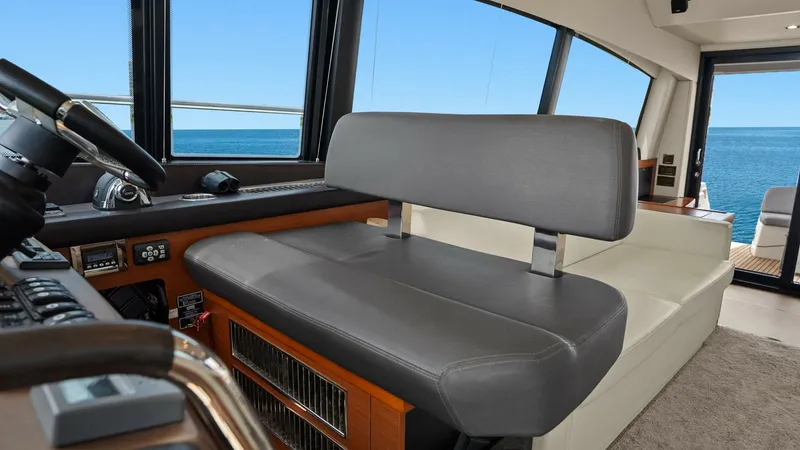 Slide: The Image of Helm Station with Ocean View The helm station of the Prestige 500 Fly offers a commanding view of the ocean through expansive windows. The sleek, cushioned seating ensures comfort during navigation, while the sophisticated dashboard features state-of-the-art controls. This space comb - 7603789