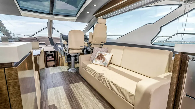 Slide: The Image of 2017 Cruisers 60 Cantius 'Rising Star' - Spacious Helm and Salon Area The helm and salon area of the 2017 Cruisers 60 Cantius 'Rising Star' boasts luxurious seating with plush leather upholstery and a panoramic view through expansive windows. The sleek design is complemented by rich wood finishes and a modern, open layout, - 7603849