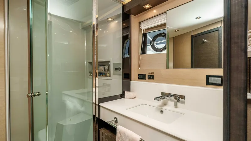 Slide: The Image of 2017 Cruisers 60 Cantius 'Rising Star' - Luxurious En-Suite Bathroom The en-suite bathroom on the 2017 Cruisers 60 Cantius features a sleek, modern design with high-end finishes. It includes a spacious glass-enclosed shower and a contemporary vanity with ample storage. The combination of soft lighting and stylish fixtures - 7603864