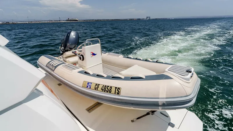 Slide: The Image of 2017 Cruisers 60 Cantius, 'Rising Star' - Aft Deck with Tender Storage The aft deck of the 2017 Cruisers 60 Cantius features a sleek, integrated tender storage area, showcasing a well-maintained inflatable tender. The tender is securely stowed, ready for quick deployment for shore excursions or leisurely exploration. This se - 7603877