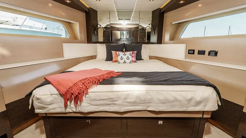 Slide: The Image of 2017 Cruisers 60 Cantius 'Rising Star' - Cozy Forward VIP Stateroom The forward VIP stateroom of the 2017 Cruisers 60 Cantius, 'Rising Star,' offers a blend of comfort and style with its spacious layout and elegant finishes. The queen-sized berth is accented by rich wood tones and ambient lighting, creating a warm and inv - 7603862