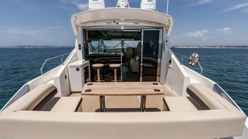 Slide: The Image of 2017 Cruisers 60 Cantius 'Rising Star' - Spacious Aft Deck with Lounge Seating The aft deck of the 2017 Cruisers 60 Cantius, 'Rising Star', features a luxurious lounge seating area with plush cushions and a central table, perfect for alfresco dining. The seamless transition to the interior through the glass doors enhances the open-c - 7603843
