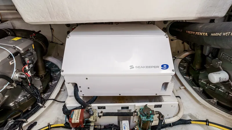 Slide: The Image of 2017 Cruisers 60 Cantius, 'Rising Star' - Seakeeper 9 Stabilizer The engine room of the 2017 Cruisers 60 Cantius showcases a Seakeeper 9 stabilizer, providing enhanced onboard comfort by reducing boat roll. The neatly organized space includes advanced Volvo Penta engines, ensuring optimal performance and reliability. T - 7603872