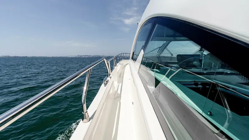 Slide: The Image of 2017 Cruisers 60 Cantius, 'Rising star' - The Side Deck Provides Easy Access to the Bow, making it Perfect for Enjoying the Sea Breeze while Navigating Coastal Waters. The sleek side deck of the 2017 Cruisers 60 Cantius offers a stunning view of the open ocean. The polished stainless-steel railings and expansive windows accentuate the vessel's modern design, ensuring safety and style. This area provides easy access to t - 7603879