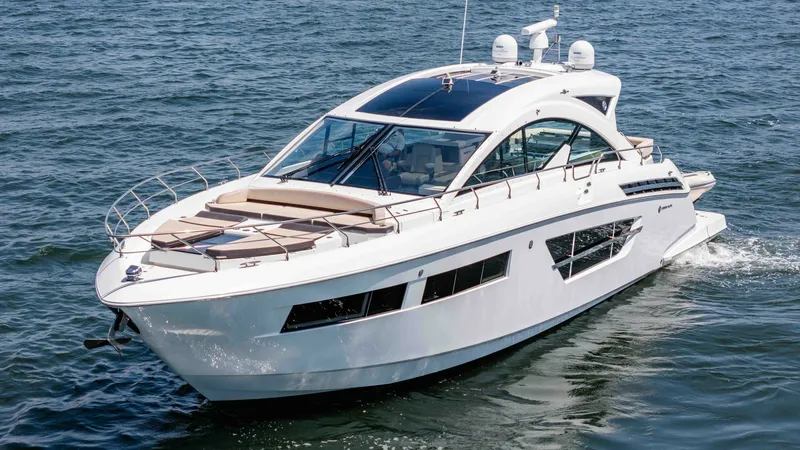 Slide: The Image of 2017 Cruisers 60 Cantius, 'Rising Star' This image showcases the sleek design of the 2017 Cruisers 60 Cantius, highlighting its expansive bow with plush sun pads for ultimate relaxation. The modern cabin features large windows, allowing natural light to flood the interior. This vessel's elegant - 7603885