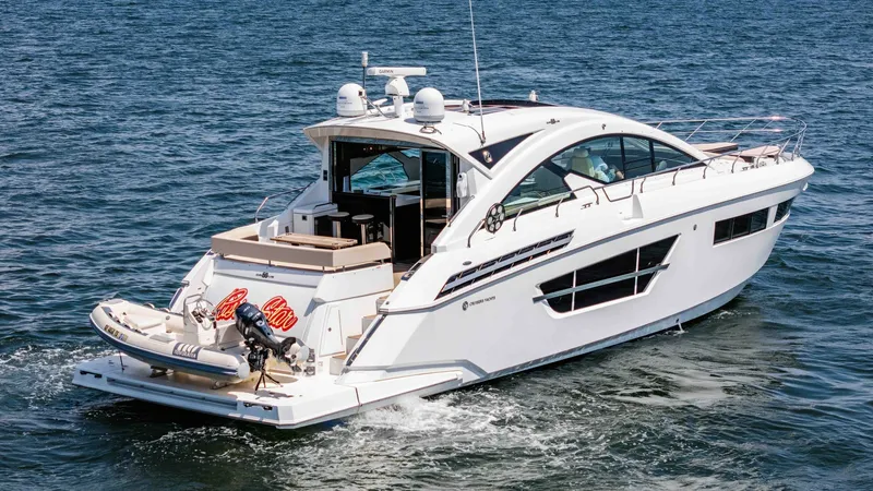Slide: The Image of 2017 Cruisers 60 Cantius, 'Rising Star' - Aft Deck and Swim Platform View The 2017 Cruisers 60 Cantius 'Rising Star' showcases an expansive aft deck, perfect for entertaining with ample seating and a sleek design. The swim platform is equipped with a tender, offering convenience for water activities. Large windows enhance the v - 7603890