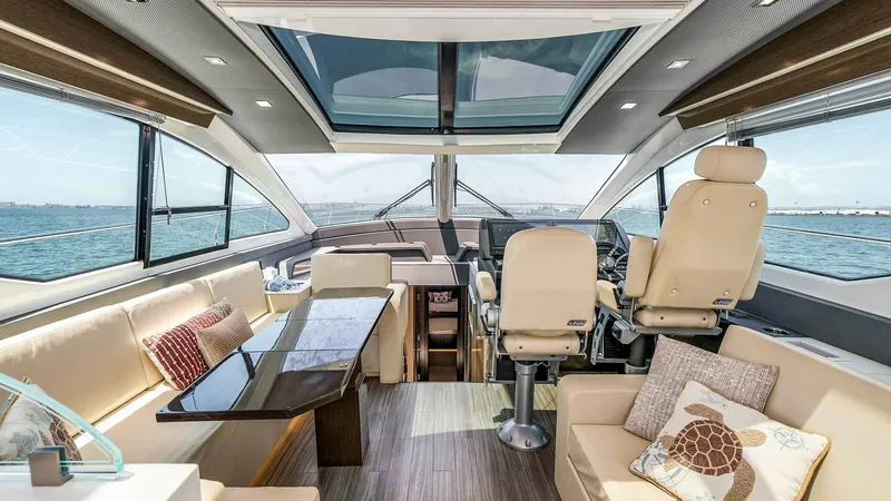 Slide: The Image of 2017 Cruisers 60 Cantius 'Rising Star' - Spacious Helm and Lounge Area The helm and lounge area of the 2017 Cruisers 60 Cantius offers a perfect blend of luxury and functionality. Featuring plush seating with elegant stitching, a sleek control console, and expansive windows, this space is designed for both comfort and panora - 7603846