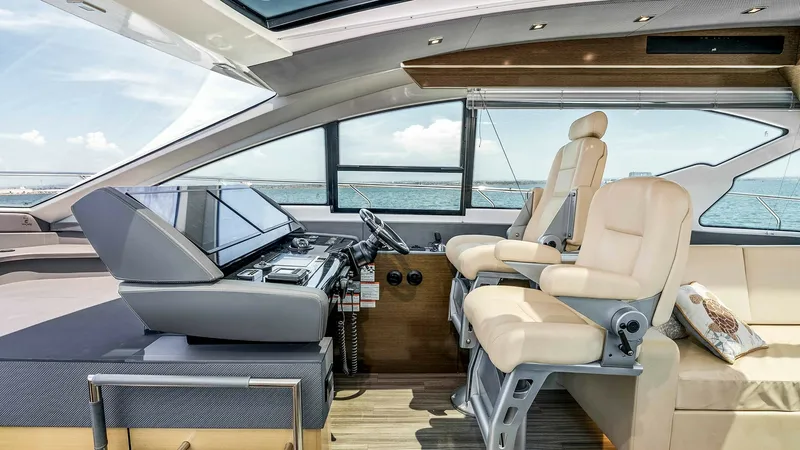 Slide: The Image of 2017 Cruisers 60 Cantius 'Rising Star' - Helm Station with Twin Seats The helm station of the 2017 Cruisers 60 Cantius 'Rising Star' offers an ergonomic design with two luxurious captain's chairs and a state-of-the-art control panel. Large windows provide panoramic ocean views, enhancing the navigation experience. The sleek - 7603851