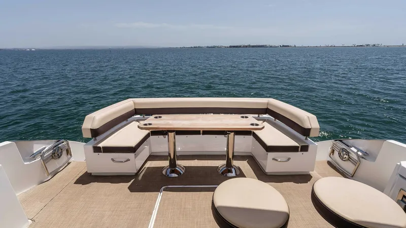 Slide: The Image of 2017 Cruisers 60 Cantius, 'Rising Star' - Aft Deck with Seating and Ocean View The aft deck of the 2017 Cruisers 60 Cantius 'Rising Star' boasts an inviting seating area with plush, wraparound benches and a stylish wooden table. This space is perfect for entertaining, offering panoramic ocean views and ample room for relaxation. The - 7603875