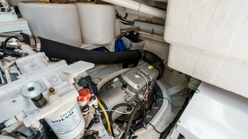 Slide: The Image of 2017 Cruisers 60 Cantius, 'Rising Star' - Engine Room with Volvo Penta System This image showcases the well-organized engine room of the 2017 Cruisers 60 Cantius, 'Rising Star.' Highlighted is the reliable Volvo Penta system, known for its efficiency and performance. The compartment is meticulously arranged, ensuring easy access fo - 7603871