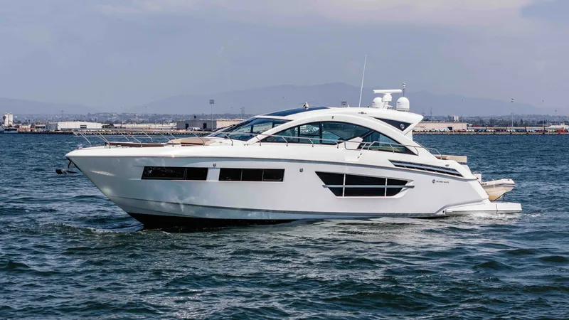 Slide: The Image of 2017 Cruisers 60 Cantius, 'Rising Star' The 2017 Cruisers 60 Cantius, known as 'Rising Star,' showcases sleek lines and a modern profile in this side view. This luxurious vessel features expansive windows that allow abundant natural light to permeate the interior. The aerodynamic design and spa - 7603886