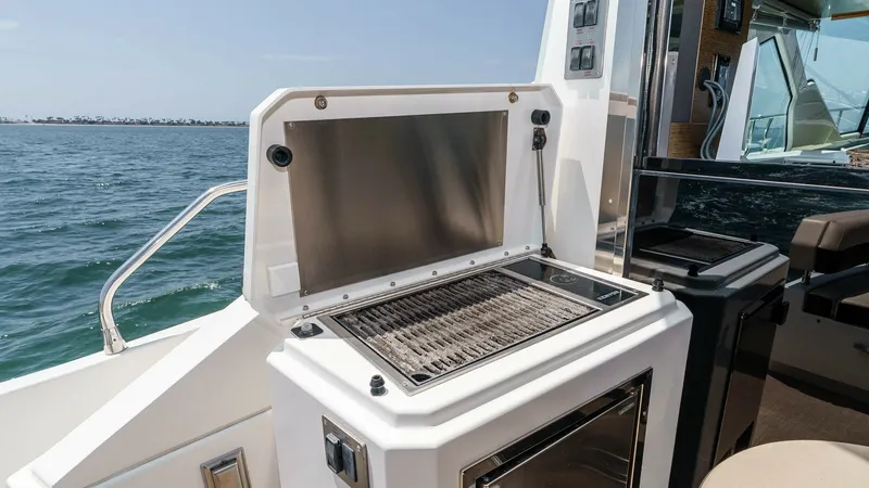 Slide: The Image of 2017 Cruisers 60 Cantius, 'Rising Star' - Outdoor Galley with Grill This image showcases the outdoor galley of the 2017 Cruisers 60 Cantius, featuring a sleek stainless steel grill perfect for alfresco dining. The compact design includes a storage compartment below, ideal for keeping essentials within reach. Situated on t - 7603874