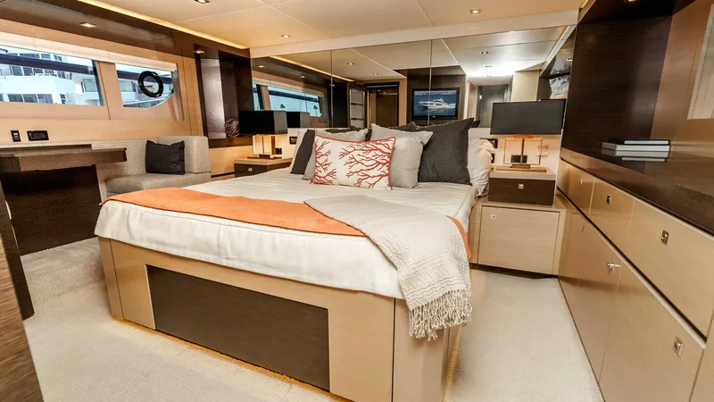 Slide: The Image of 2017 Cruisers 60 Cantius 'Rising Star' - Master Stateroom with Queen Bed The master stateroom offers a spacious queen-sized bed adorned with plush pillows and a cozy throw. Elegant wood finishes and ample natural light create a warm and inviting atmosphere. The room features a well-appointed vanity and abundant storage, perfec - 7603857