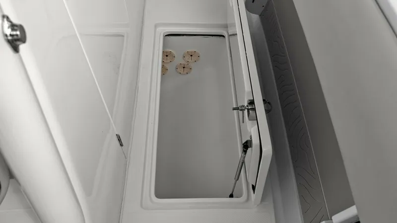 Slide: The Image of Spacious In-Deck Storage Compartment This image showcases the ample in-deck storage compartment of the 2025 Jupiter 30 HFS. Designed for practicality and ease, the compartment features a sturdy lid with secure latching mechanisms. The clean, white finish and well-organized space are ideal fo - 7718736