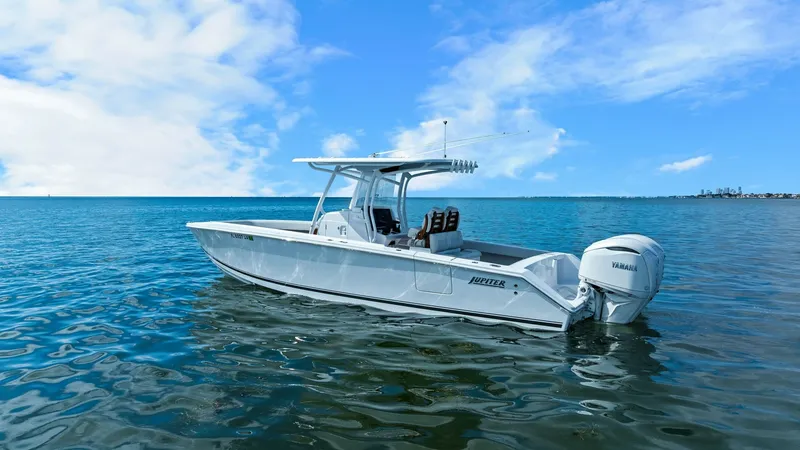 Slide: The Image of Side Profile on Open Water This image showcases the sleek side profile of the 2025 Jupiter 30 HFS, gliding effortlessly on open waters. The elegant, streamlined hull design is complemented by a sturdy T-top, providing ample shade and protection. Equipped with twin Yamaha engines, t - 7718745
