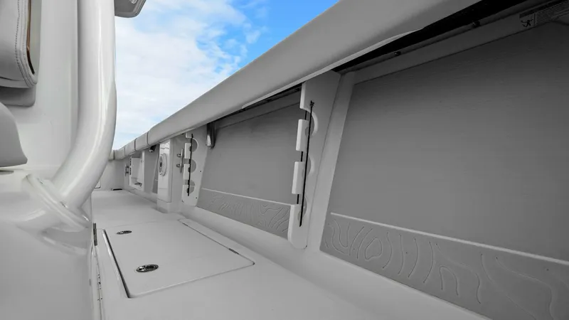 Slide: The Image of Starboard Gunwale Storage Compartment This image showcases the starboard gunwale storage compartment on the 2025 Jupiter 30 HFS. The design maximizes space utilization with sleek, integrated hatches for storing fishing rods and gear securely. The durable construction and subtle detailing comp - 7718737