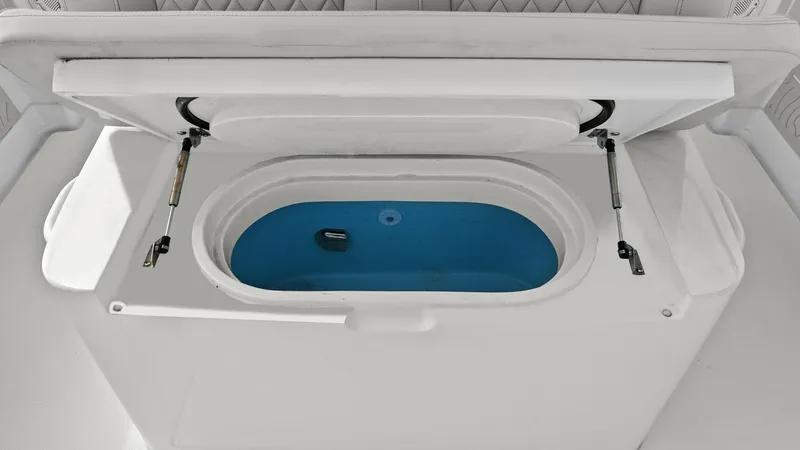 Slide: The Image of Integrated Livewell with Padded Seating This image showcases the integrated livewell of the 2025 Jupiter 30 HFS, designed for optimal fishing convenience. The livewell features a spacious, insulated compartment with a blue interior, enhancing visibility of the catch. The padded seating above of - 7718735