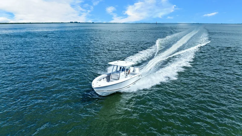 Slide: The Image of Aerial View of Jupiter 30 HFS Cruising This image showcases the 2025 Jupiter 30 HFS slicing through open waters with grace and power. The sleek hull design enhances its performance, while the T-top provides essential shade and shelter. Perfect for both leisure and fishing, this vessel combines - 7718753