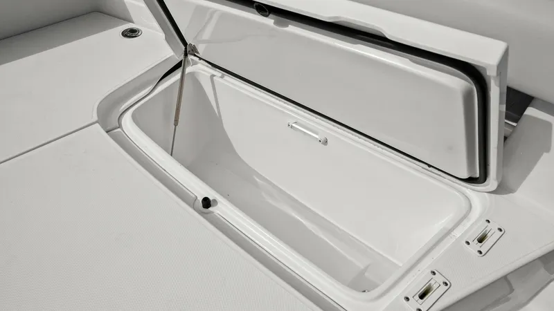 Slide: The Image of Spacious Deck Storage Compartment This image showcases the ample deck storage compartment of the 2025 Jupiter 30 HFS. The compartment is designed with a durable, easy-to-clean finish, providing plenty of space for gear and essentials. The secure latching system and hydraulic lift ensure c - 7718728