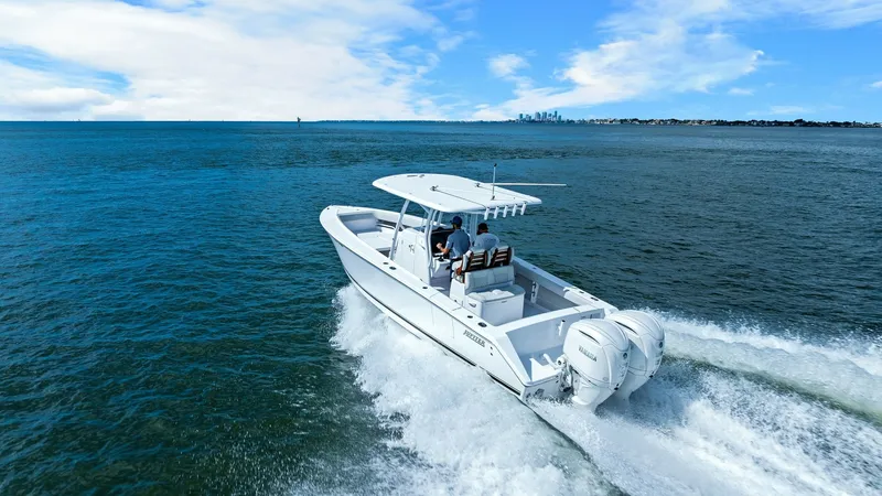 Slide: The Image of Aft View with Dual Engines This image showcases the sleek aft section of the 2025 Jupiter 30 HFS, featuring dual powerful outboard engines for optimal performance. The spacious deck provides ample seating and an unobstructed view, ideal for both relaxation and fishing adventures. T - 7718749