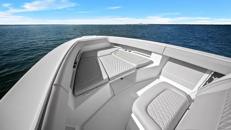 Slide: The Image of Spacious Bow Seating Area The 2025 Jupiter 30 HFS features a luxurious bow seating area, perfect for relaxation and socializing. The plush, diamond-stitched upholstery complements the sleek design, offering comfort and style. Surrounded by panoramic views, this area is ideal for e - 7718725