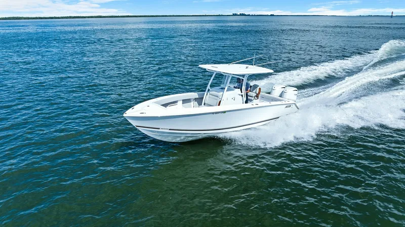 Slide: The Image of Jupiter 30 HFS Aerial View The 2025 Jupiter 30 HFS glides effortlessly across the water, showcasing its sleek and modern design. The spacious deck provides ample room for fishing and relaxation, while the T-top offers shade and protection. Powered by twin outboard engines, this mod - 7718752