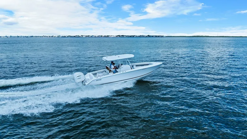Slide: The Image of Jupiter 30 HFS Cruising at Speed The 2025 Jupiter 30 HFS is shown gliding effortlessly across the open water, showcasing its sleek hull design and powerful twin outboard engines. The center console layout provides ample space for navigation and comfort, while the T-top offers protection - 7718755