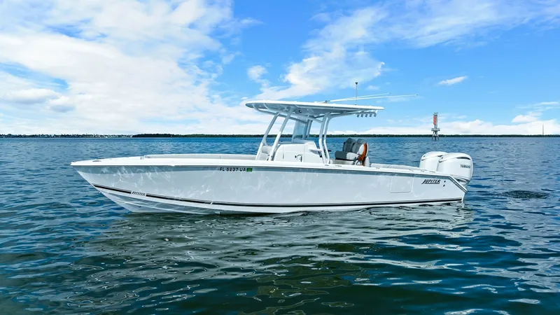 Slide: The Image of Side Profile of Jupiter 30 HFS The 2025 Jupiter 30 HFS is captured in a stunning side profile, showcasing its sleek, modern design and robust hull. The vessel features a spacious T-top providing ample shade, while the dual outboard engines promise powerful performance. Its elegant whit - 7718744