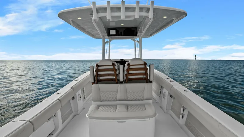 Slide: The Image of Cockpit and Helm Seating Area The cockpit of the 2025 Jupiter 30 HFS showcases a spacious and meticulously designed seating area. It features plush, diamond-stitched upholstery, providing both comfort and style for passengers. The helm is shaded by a robust T-top, complete with integr - 7718739