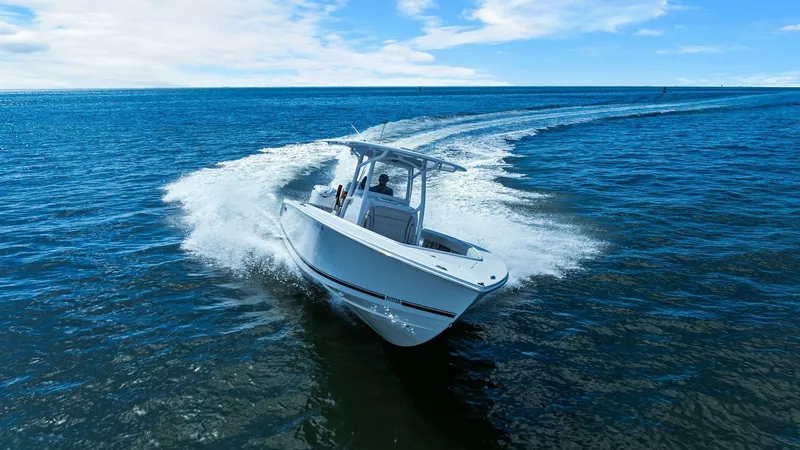 Slide: The Image of Aerial View of Jupiter 30 HFS Cruising The 2025 Jupiter 30 HFS is captured in action, showcasing its sleek design and powerful performance on open water. The clean lines and sophisticated hull ensure a smooth and efficient ride, while the T-top provides shade and style. This model is perfect f - 7718757