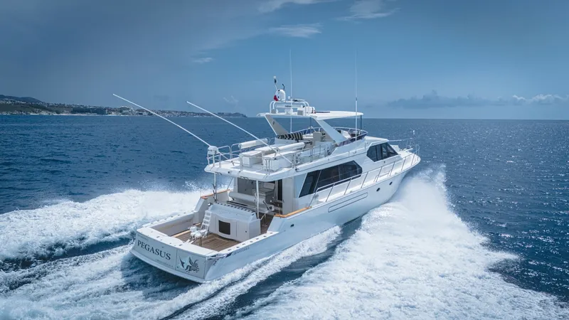 Slide: The Image of Aft View in Motion The 2002 West Bay 58 Enclosed Bridge, Pegasus, is seen cruising effortlessly through open waters, showcasing its powerful and sleek design. The aft deck offers ample space for relaxation and entertainment, while the enclosed bridge ensures comfort and vis - 7669006