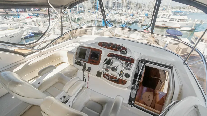 Slide: The Image of Flybridge Helm Station with Seating The flybridge helm station of the 2005 Meridian 540 Pilothouse features a well-appointed control area with a modern dashboard and dual seating. The expansive views through the large windows enhance navigation, while the comfortable leather seats provide a - 7721590