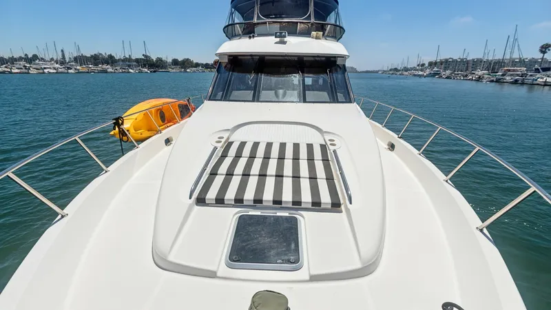 Slide: The Image of Spacious Bow with Sun Pad The bow of the 2005 Meridian 540 Pilothouse features a generous sun pad with stylish striped cushions, ideal for lounging and enjoying the open water views. Stainless steel railings provide safety and elegance, while the sleek lines of the deck enhance th - 7721619